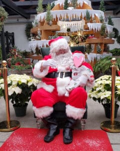 Infant sitting with Santa Claus | Your guide to family-friendly holiday adventures in Billings | Better Off In Billings