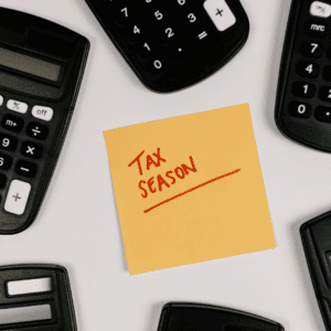 Tax Season on post it surrounded by calculators | Getting Your Taxes done in Billings | Better Off In Billings